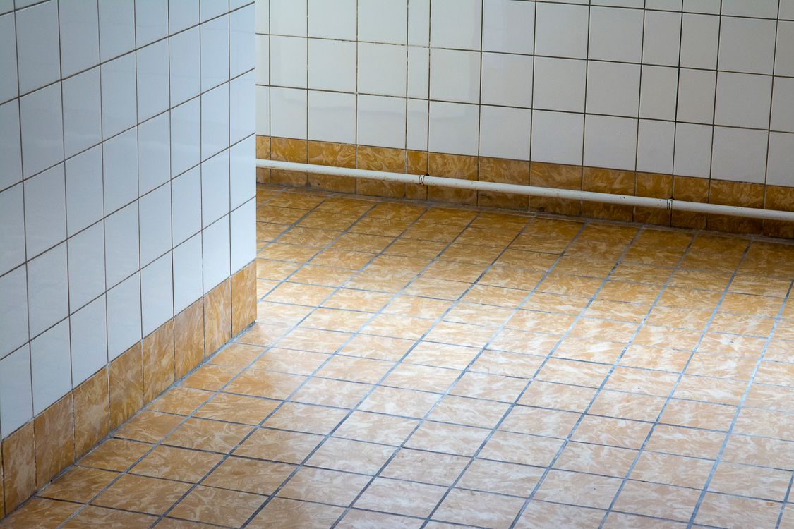 Clean tile and grout in a communal restroom
